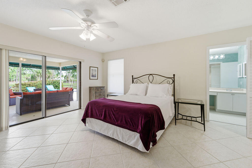5562 Reynolds Road Lake Worth, FL 33449 - Photo 7 of 39 a spacious bedroom with a bed and glass door