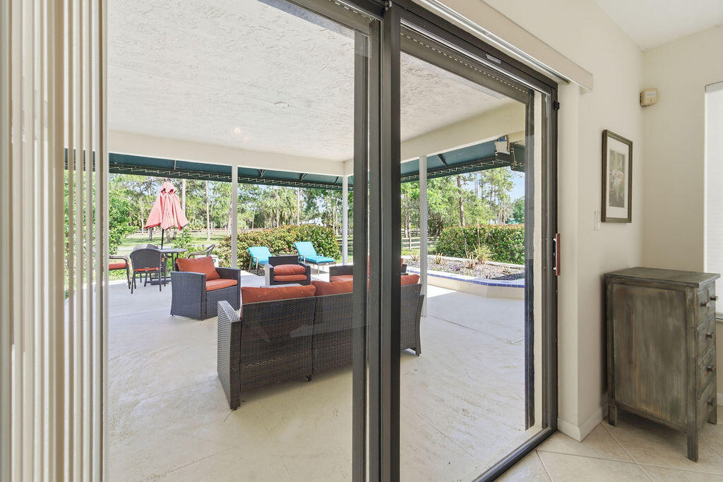 5562 Reynolds Road Lake Worth, FL 33449 - Photo 9 of 39 a room with furniture and a floor to ceiling window