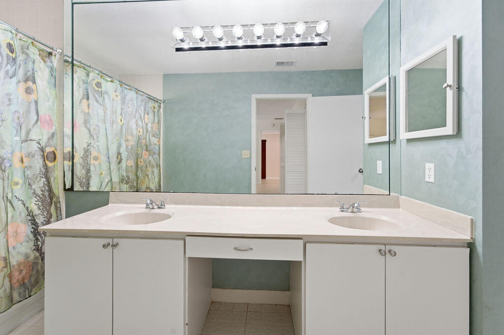 5562 Reynolds Road Lake Worth, FL 33449 - Photo 10 of 39 a bathroom with a sink and a mirror