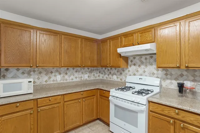 a kitchen with a sink a stove and cabinets