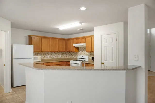 a view of an empty room and a bathroom