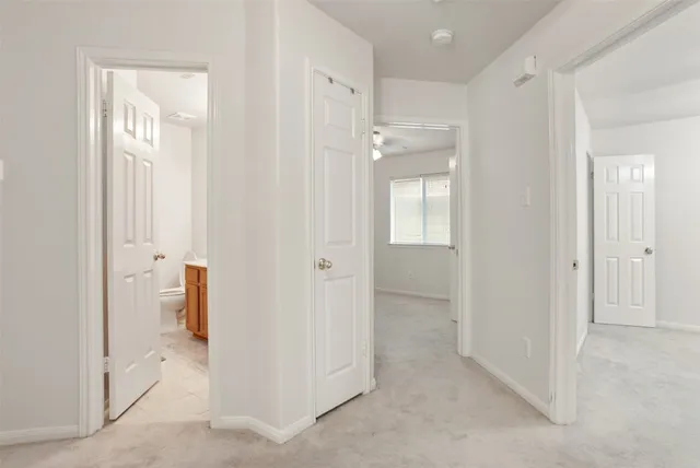 an empty room with a fan and a fan