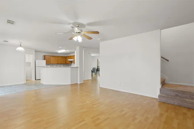 a view of a kitchen with a sink and a refrigerator