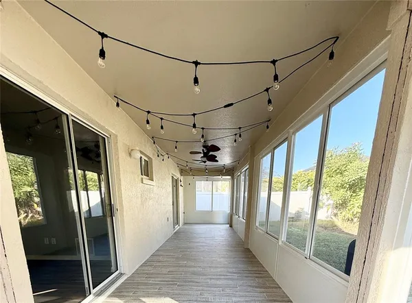 a view of a hallway with wooden floor and door