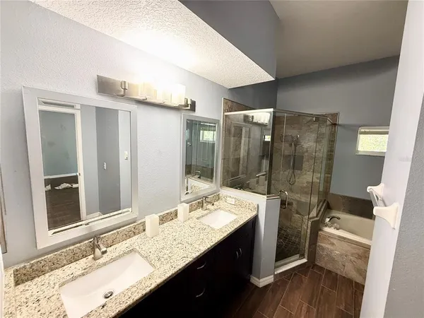 a bathroom with a granite countertop sink mirror and double