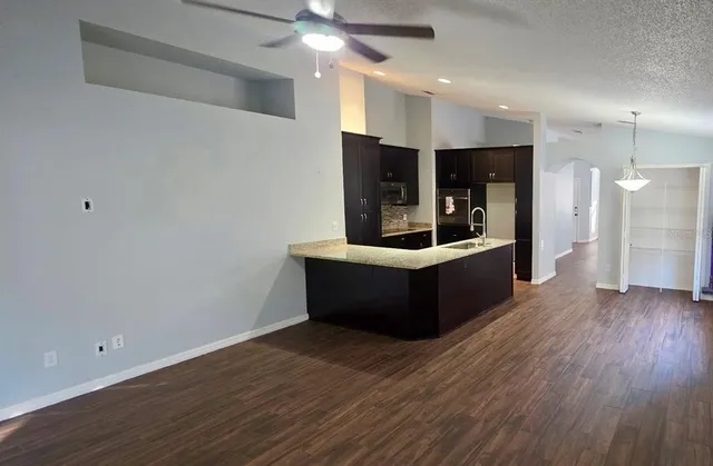 a view of a room with wooden floor and a sink