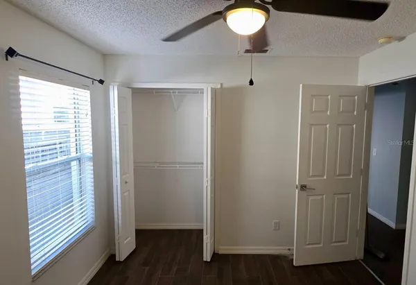 a view of empty room with wooden floor