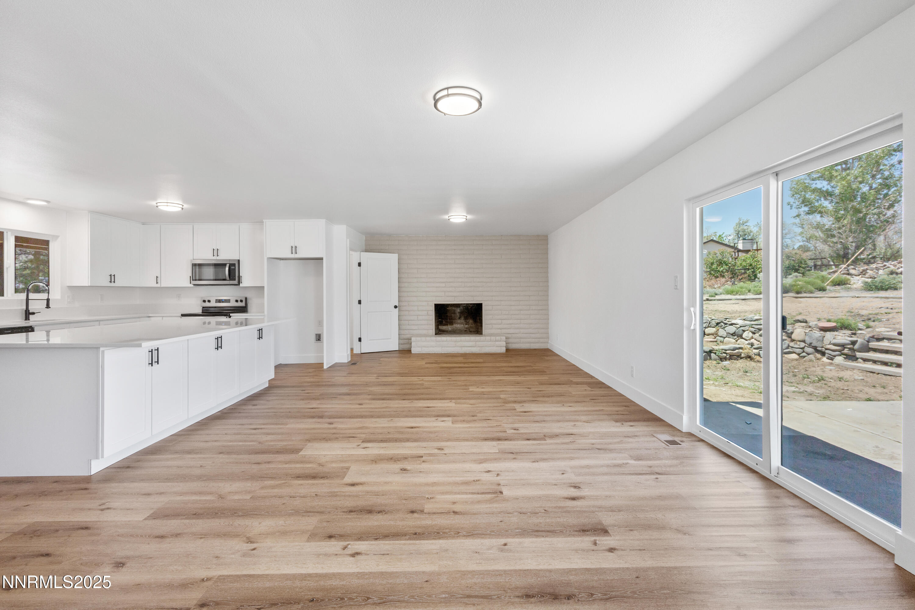 10835 Silver Knolls Boulevard Reno, NV 89508 - Photo 15 of 43 a large white kitchen with kitchen island a sink stainless steel appliances and cabinets