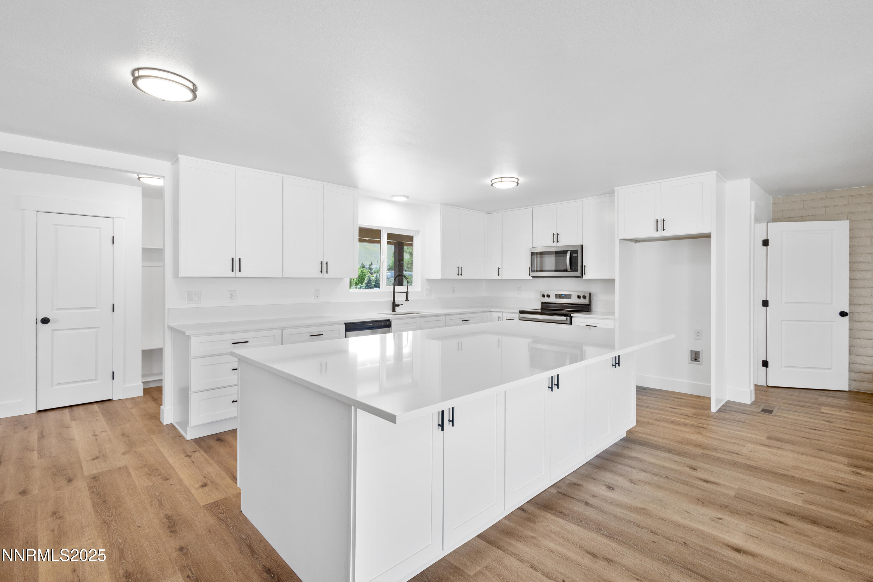 10835 Silver Knolls Boulevard Reno, NV 89508 - Photo 19 of 43 a kitchen with white cabinets sink and white stainless steel appliances