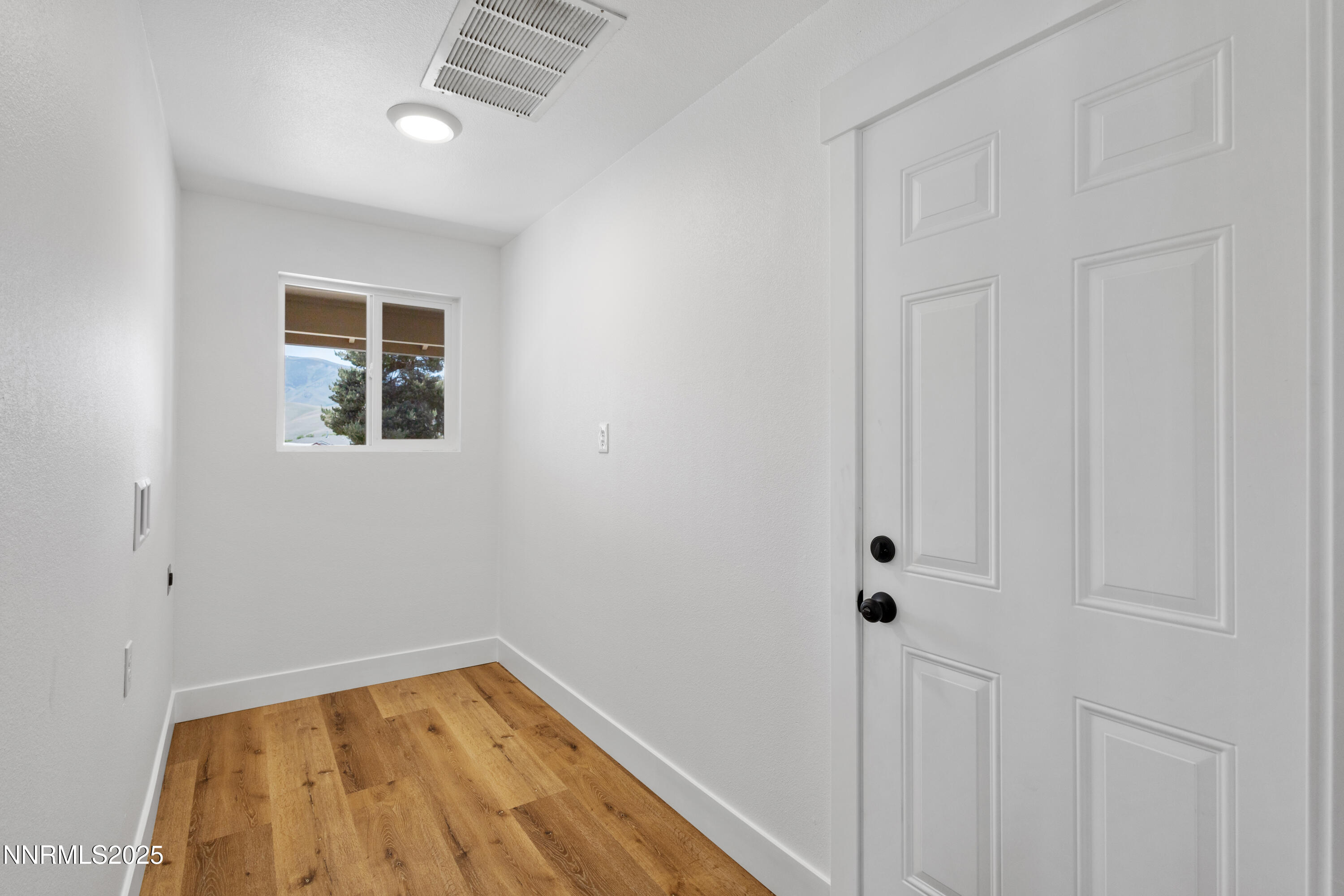 10835 Silver Knolls Boulevard Reno, NV 89508 - Photo 30 of 43 a view of a bedroom with wooden floor and a window