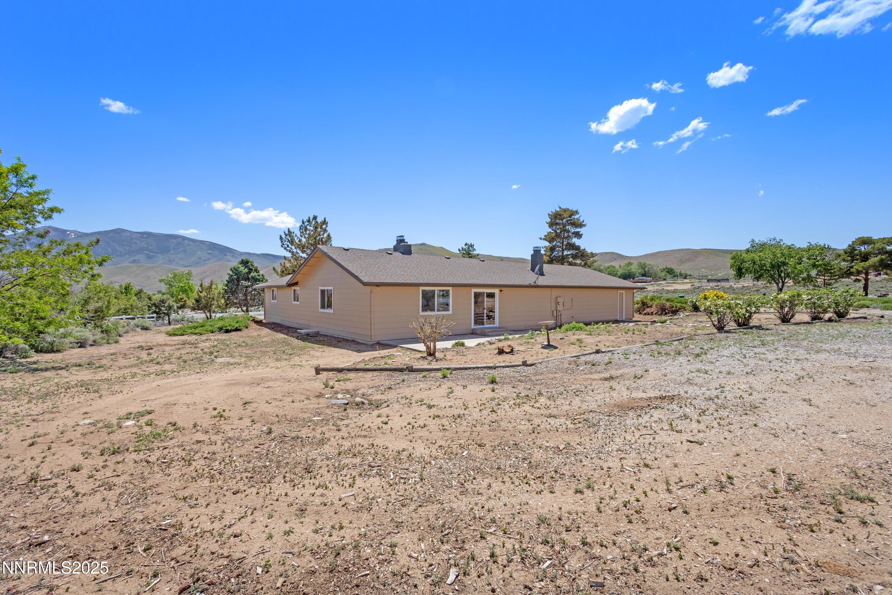 10835 Silver Knolls Boulevard Reno, NV 89508 - Photo 31 of 43 a view of a dry yard with a house in the background