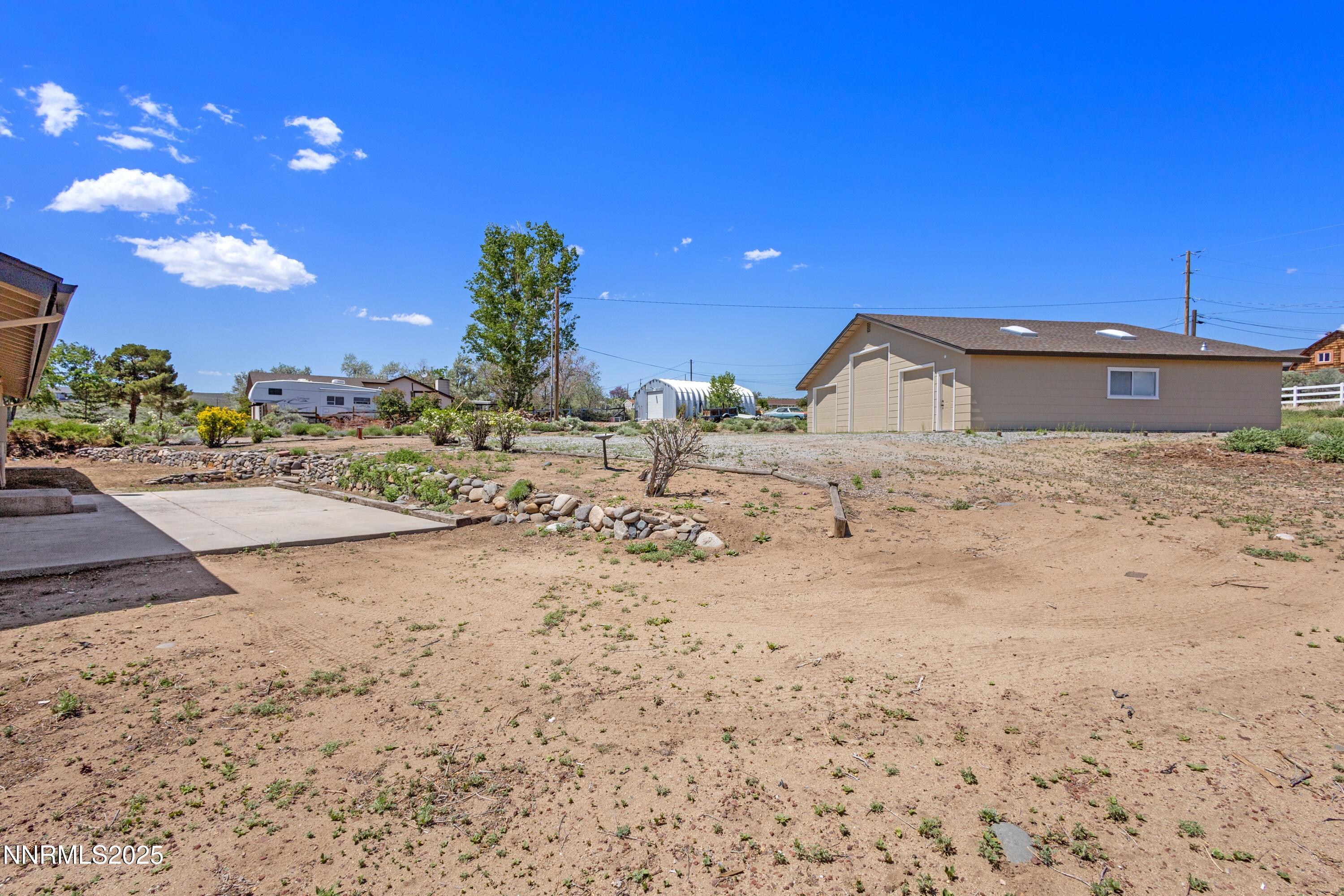 10835 Silver Knolls Boulevard Reno, NV 89508 - Photo 32 of 43 a view of a dry yard with a house in the background