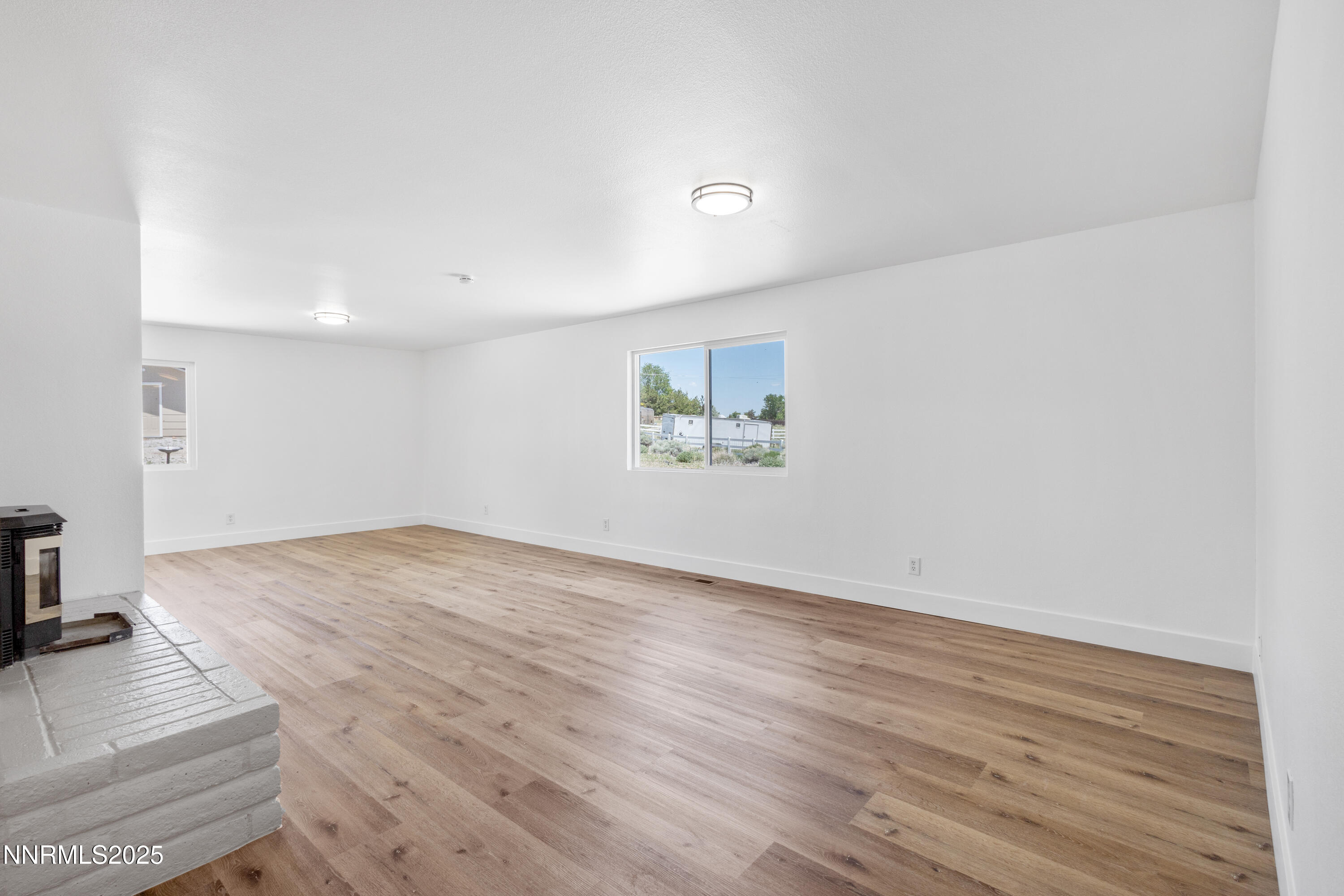 10835 Silver Knolls Boulevard Reno, NV 89508 - Photo 9 of 43 an empty room with wooden floor and a window