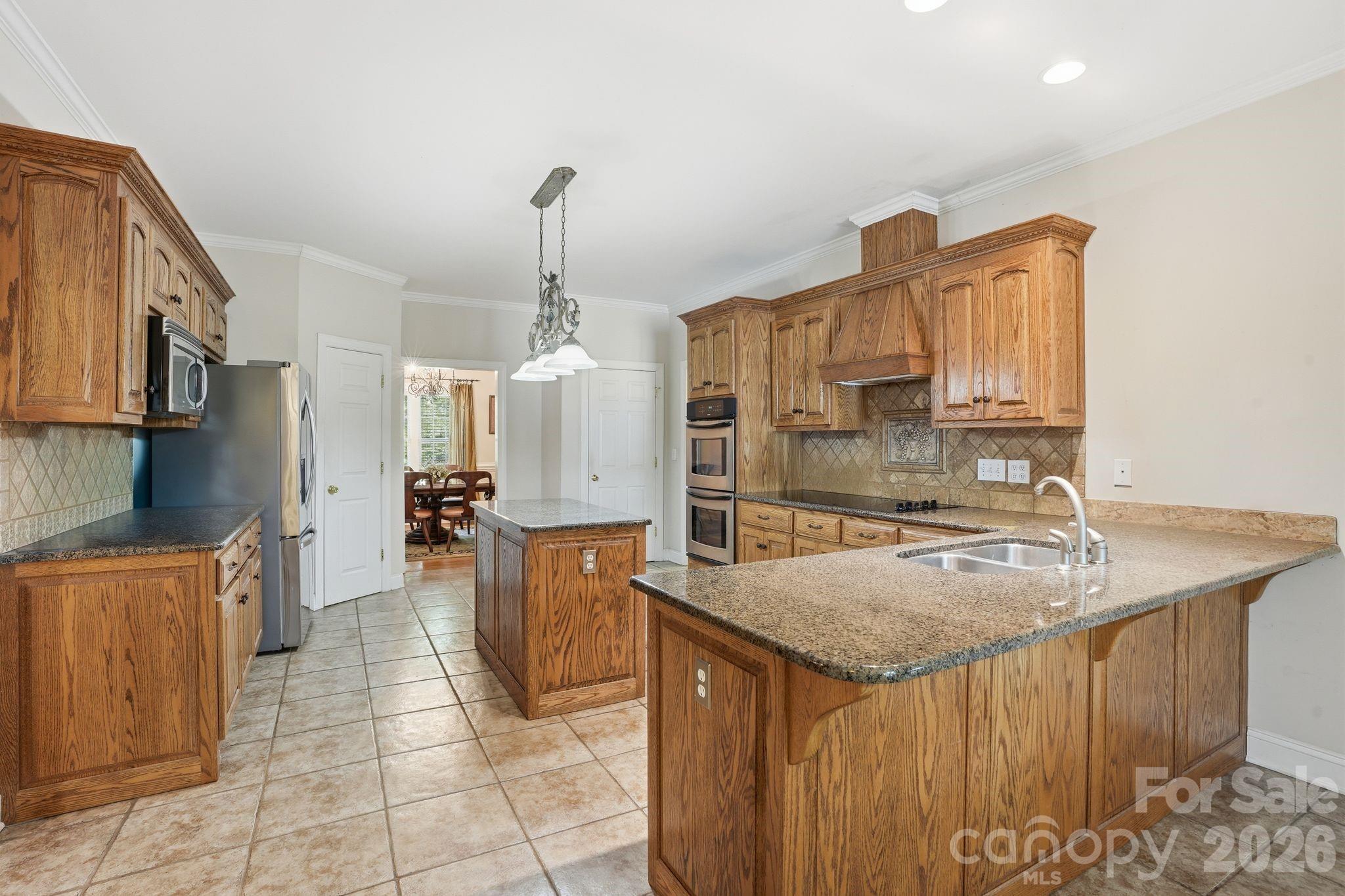 2275 River Road Richfield, NC 28137 - Photo 15 of 44 a kitchen with a sink a counter top space and stainless steel appliances