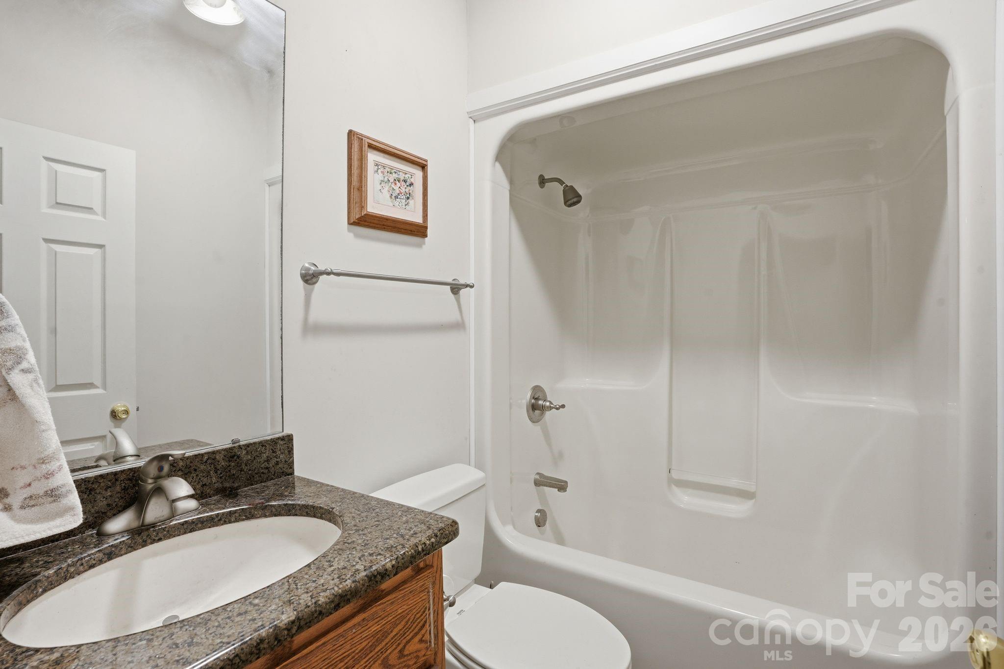 2275 River Road Richfield, NC 28137 - Photo 29 of 44 a bathroom with a granite countertop sink toilet and shower