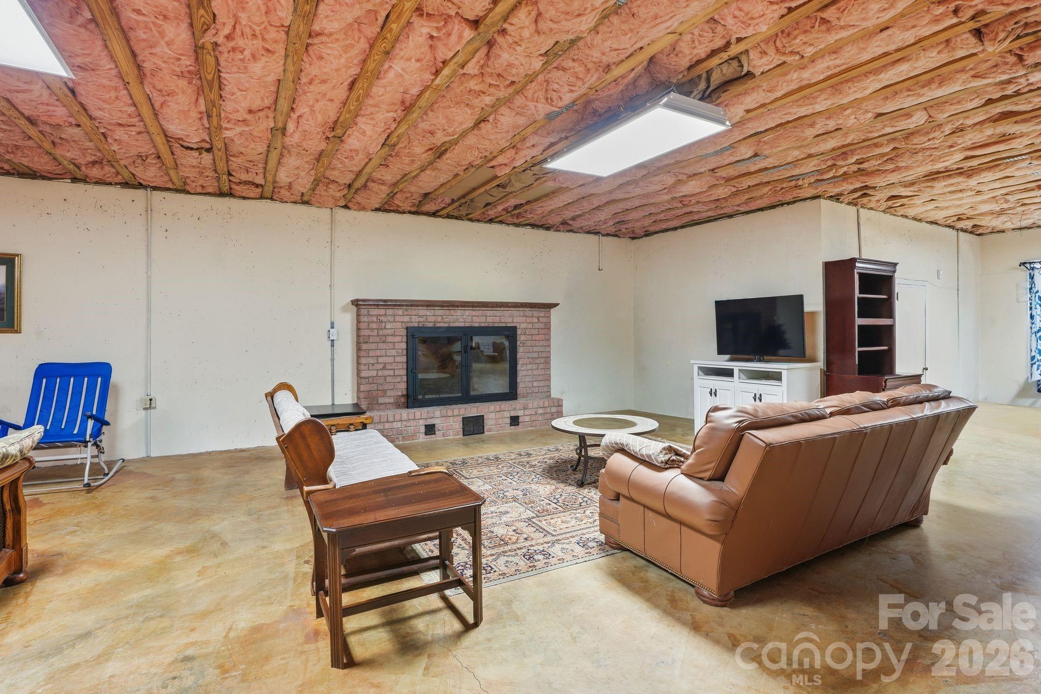 2275 River Road Richfield, NC 28137 - Photo 34 of 44 a living room with furniture a flat screen tv and a table