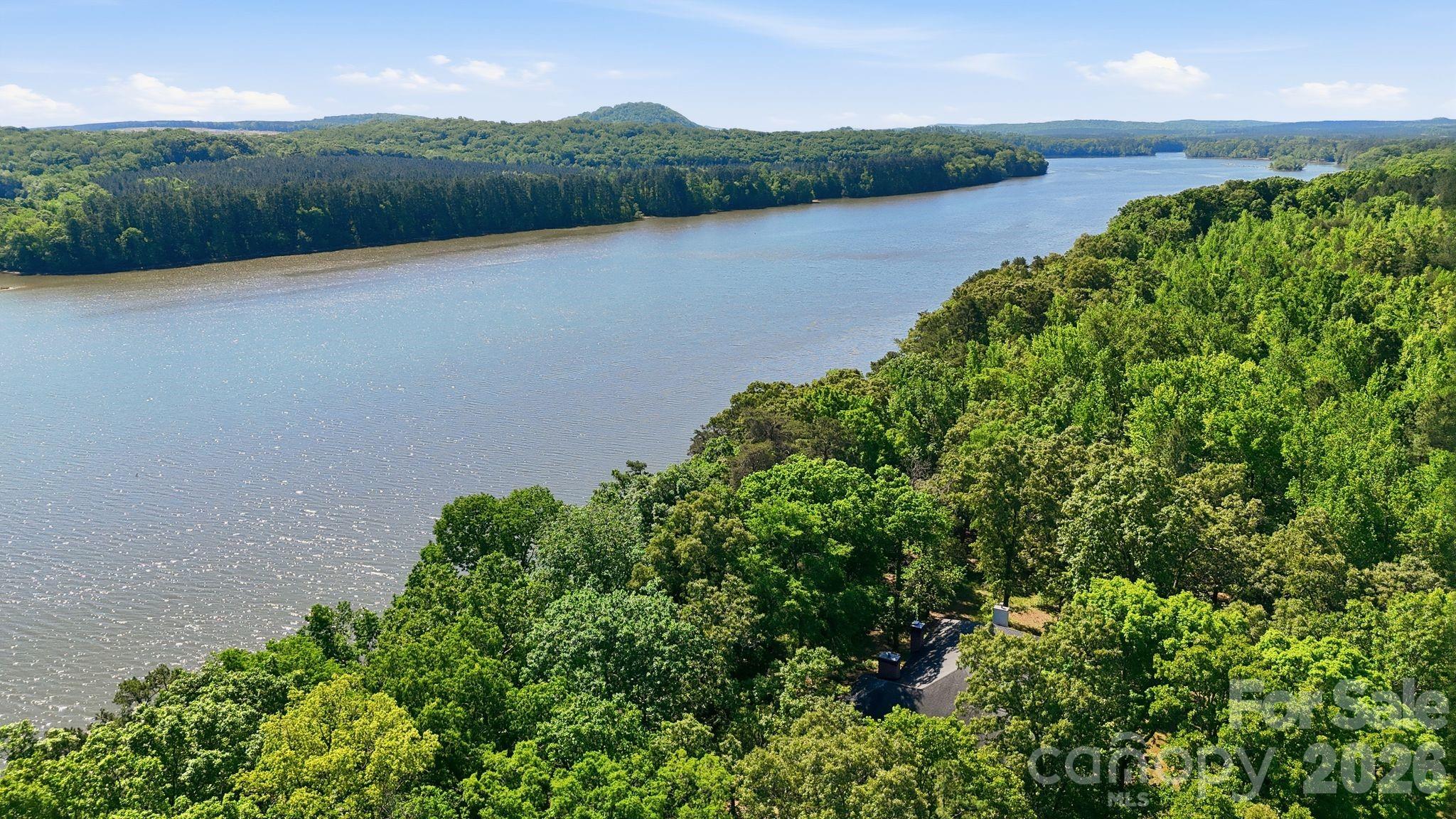 2275 River Road Richfield, NC 28137 - Photo 5 of 44 a view of a lake with a mountain in the background