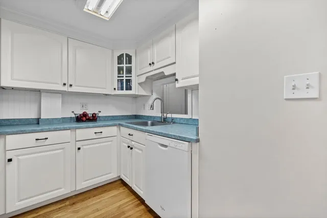 a kitchen with granite countertop white cabinets and white appliances