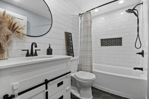 a bathroom with a toilet a sink and a mirror