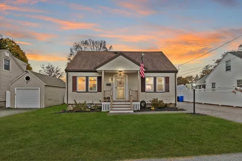 a front view of a house with a garden