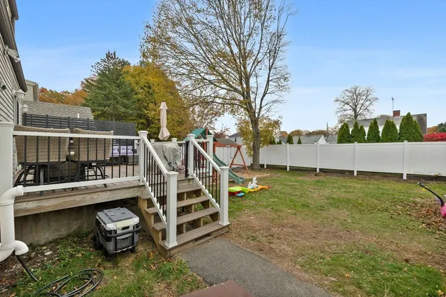 a view of a house with backyard and sitting area