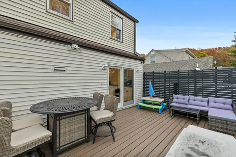 a balcony with wooden floor and furniture