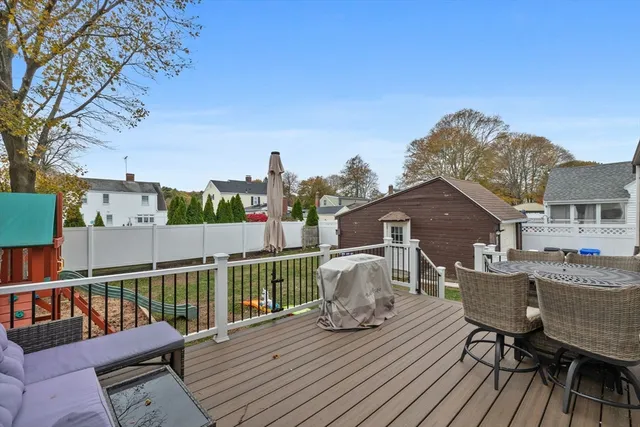 a view of a deck with furniture and a barbeque