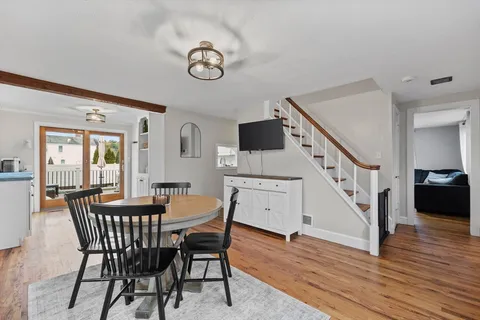 a dining room with furniture and wooden floor
