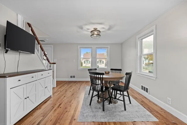 a view of a dining room with furniture and window