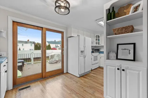 a view of a hallway with wooden floor and entryway