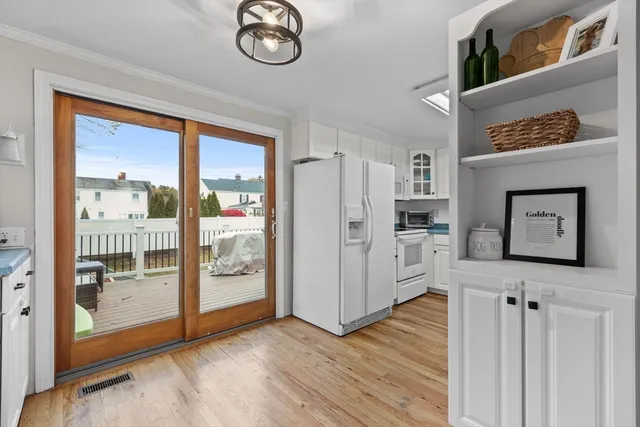 a view of a hallway with wooden floor and entryway