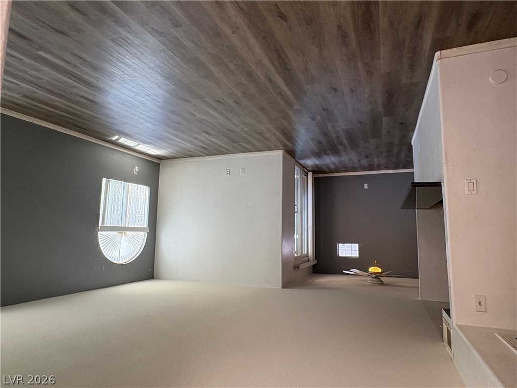 9325 West Desert Inn Road, Unit 123 Las Vegas, NV 89117 - Photo 7 of 36 Laminate flooring extends across the ceiling, complementing the interior walls and window features.