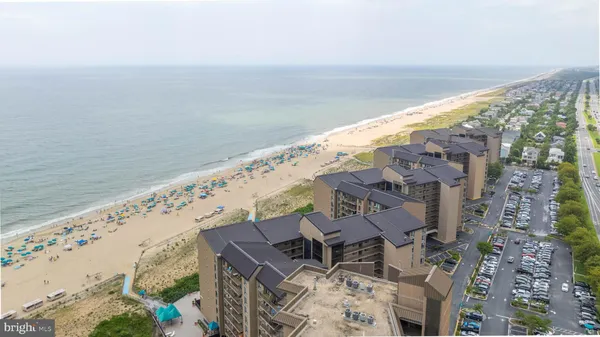 a view of a floor to ceiling window an ocean view
