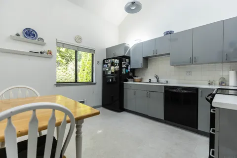 a kitchen with stainless steel appliances a stove a sink a refrigerator and window