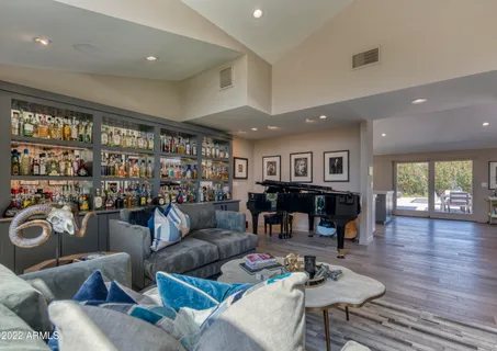 a living room with furniture fireplace and a large window