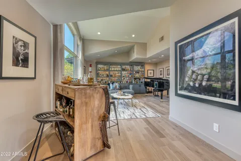 a living room with furniture and a book shelf