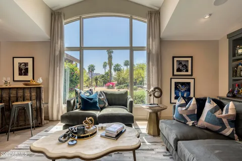a living room with furniture and a potted plant