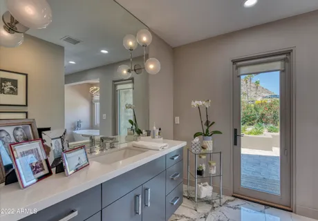 a spacious bathroom with a sink a mirror and a shower