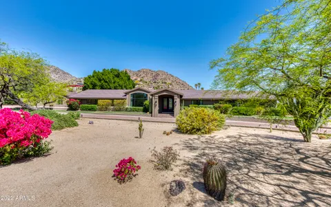 a view of an entryway with wooden floor and a fireplace