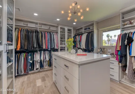 a bedroom with furniture and a large window