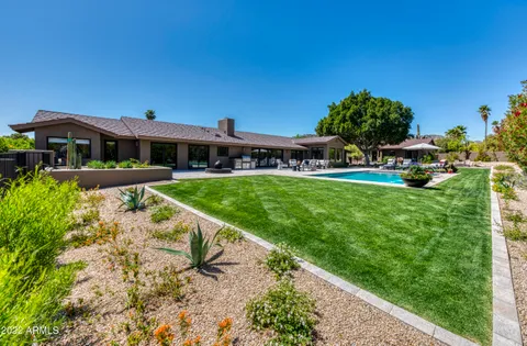 a view of an house with swimming pool garden and patio