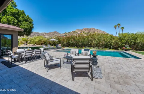 swimming pool view with a seating space