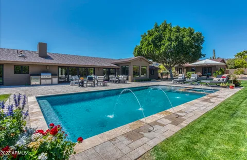 a kitchen with stainless steel appliances kitchen island granite countertop a stove and a refrigerator