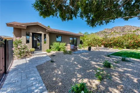 a bathroom with a granite countertop toilet sink and mirror