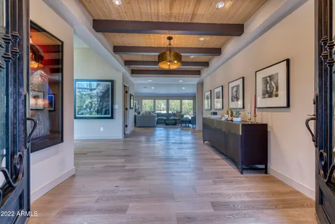 a living room with furniture large window and a fireplace