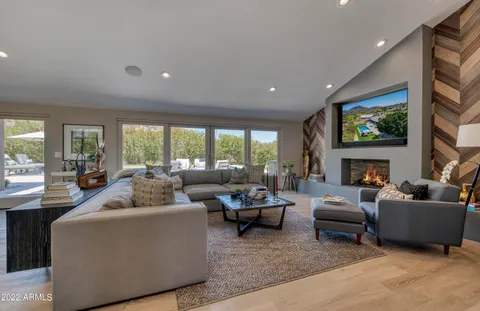 a living room with furniture fireplace and window
