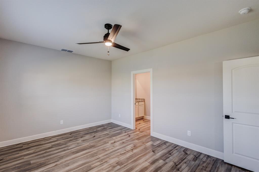 1816 Jeanine Drive Anna, TX 75409 - Photo 11 of 23 a view of an empty room with wooden floor