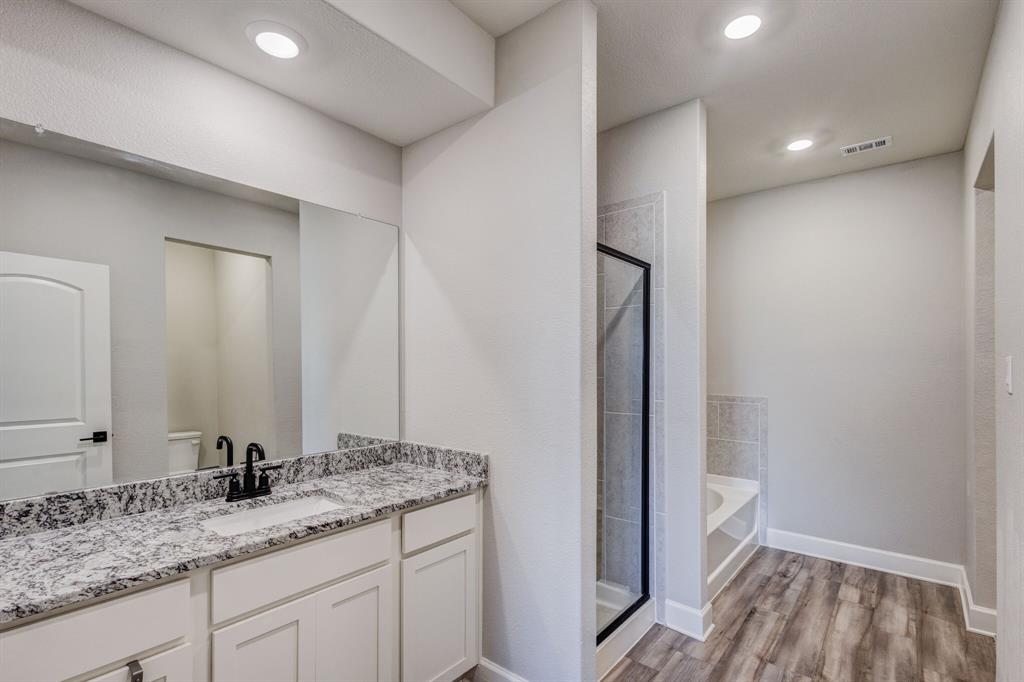 1816 Jeanine Drive Anna, TX 75409 - Photo 12 of 23 a bathroom with a granite countertop sink and a mirror