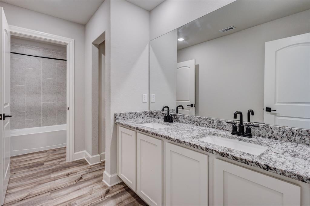 1816 Jeanine Drive Anna, TX 75409 - Photo 20 of 23 a bathroom with a sink and a mirror