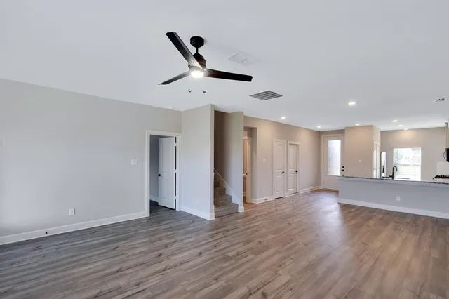 a view of a room with wooden floor and windows